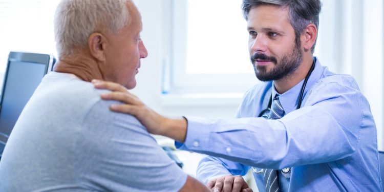 Male doctor examining a patient at the hospital